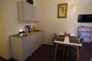 a small kitchen with a table and a table and chairs at Panda House - Luxury in Old Town in Tartu