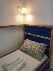 a small bed with a pillow and a lamp at Sole e Luna in Marina di Modica