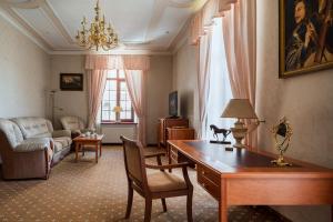 a living room with a desk and a couch at Mozart Hotel in Odesa