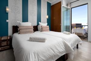 Ένα ή περισσότερα κρεβάτια σε δωμάτιο στο Pérola Views Inn by Madeira Sun Travel