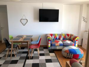 a living room with a couch and a table at Portorož Apartments in Portorož