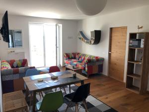 a living room with couches and a table and chairs at Portorož Apartments in Portorož