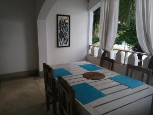 uma sala de jantar com uma mesa com guardanapos azuis em Blue Marlin Sporting Resort em Melinde