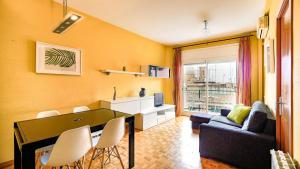 a living room with a couch and a table and chairs at Bed&Bcn Sant Andreu in Barcelona