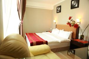 a hotel room with a bed and a couch at Park Hotel in Ulaanbaatar +37 photos