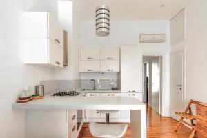 a kitchen with white cabinets and a white counter top at Torre a mare Sun in Torre a Mare
