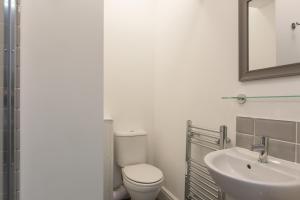 a bathroom with a toilet and a sink at Townhouse PLUS @ 130 West Street Crewe in Crewe