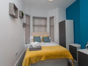 a bedroom with a large bed with towels on it at Townhouse @ 166 Ruskin Road Crewe in Crewe