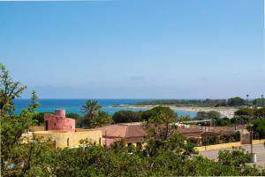 a view of a beach with a building and the ocean at Casa Deidda in Villaputzu
