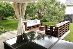 a patio with a couch and a glass table at Ferienwohnung mit Sauna und schönem Garten in Rottweil