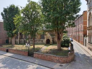 an old building with trees in front of a street at St Martins View in York