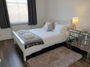 a bedroom with a white bed and a window at St Martins View in York