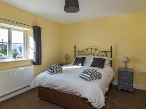 a bedroom with a bed with two pillows on it at 700 Westport in Langport