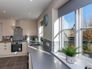 a kitchen with a counter with a sink and a window at 700 Westport in Langport