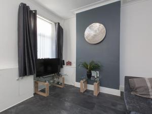 a living room with a television and a window at Townhouse @ 83 Edleston Road Crewe in Crewe