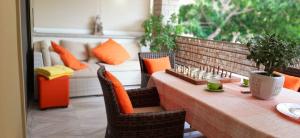 a patio with a table and chairs and a couch at Sandy's apartment in Ancient Epidauros