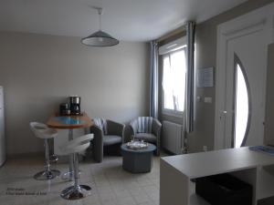 a living room with chairs and a table and a window at Studio Chez Jose in Albert