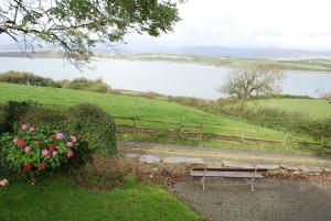 a park bench with a view of a lake at Dromcloc House in Bantry