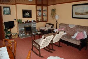 een woonkamer met een bank en een open haard bij Dromcloc House in Bantry