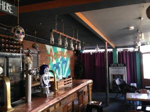a bar in a restaurant with skulls on the wall at Acapulco Rooms in Portsmouth