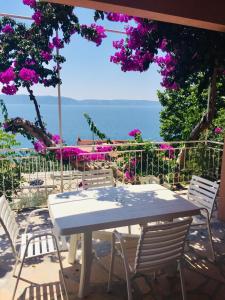 a table and chairs with a view of the ocean at Apartments Juraković in Živogošće
