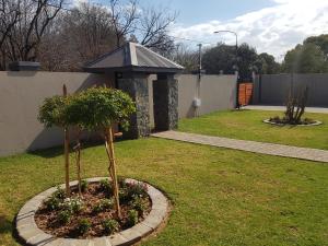 a garden with a small tree in a circle at The Royal Prime Guest Lodge in Centurion