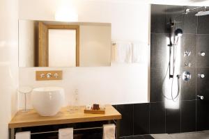 a bathroom with a sink and a shower at Firefly Luxury Suites in Zermatt