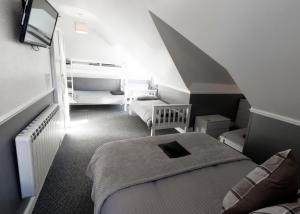 a small room with two beds and a staircase at The Aldor in Skegness