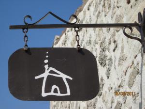 a sign hanging on the side of a building at A la Maison d'Hôtes in La Baume-de-Transit