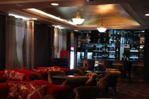 a room with couches and a bar in a restaurant at Park Hotel in Ulaanbaatar