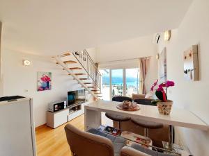 a living room with a spiral staircase in a apartment at Design Apartments Bonavista in Opatija