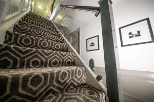a set of stairs with a carpeted stair case at Amarillo Guesthouse in Bournemouth