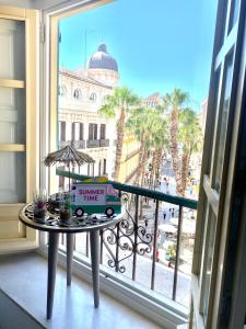 a balcony with a table with a delivery truck on it at NATURA SUITE MÁLAGA in Málaga