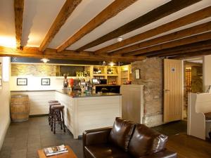 a living room with a kitchen and a bar at The Anchor Inn in Ivybridge