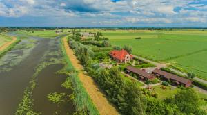 an aerial view of a house next to a river at Stanica Przygody in Sztutowo