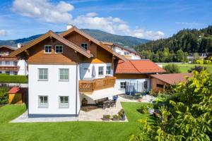 a large house with a wooden roof at Annas - Appartements in Flachau