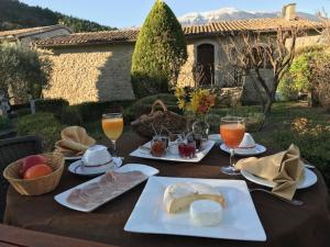 a table with plates of food and drinks on it at LA BAPTISTINE FACE AU VENTOUX in Plaisians