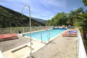 a swimming pool with a view of a mountain at LA BAPTISTINE FACE AU VENTOUX in Plaisians
