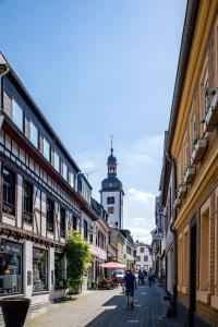 a city street with a clock tower in the distance at Pension Herheinspaziert in Bad Breisig