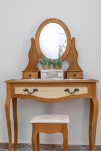 a dressing table with a mirror and a stool at Vintage House Naxos in Glinado Naxos