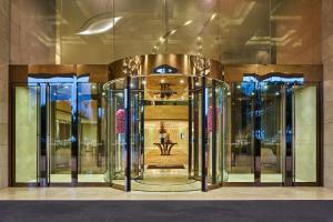 a lobby with a revolving door in a building at Crowne Plaza Zhenjiang by IHG in Zhenjiang