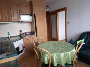 a small kitchen with a table with a green table cloth at Apartmán v centre Žiliny in Žilina