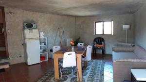 a living room with a table and a refrigerator at Cynda´s home in Viseu
