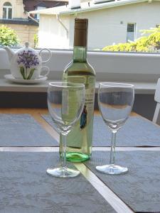 a bottle of wine and two wine glasses on a table at 13 Sopot in Sopot