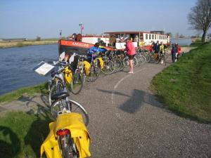 bicycles are parked along the side of the road at Hotelboat Angeline in Amsterdam