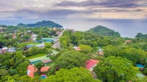 a scenic view of a city with trees and houses at Hotel Villas Lirio in Manuel Antonio