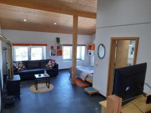 a living room with a couch and a bed at Quinta Quatro Ventos in Sertã