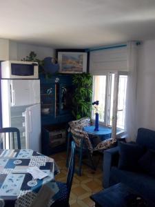 a living room with a table and a refrigerator at Rosas-Puig Rom -VISTA MAR in Roses
