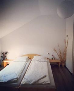 a bedroom with two beds and a wooden table at Casa Raul in Coramnic +29 photos