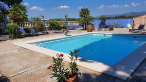 a large blue swimming pool in a yard at Hotel Restaurant El Bosc in Banyeres del Penedes